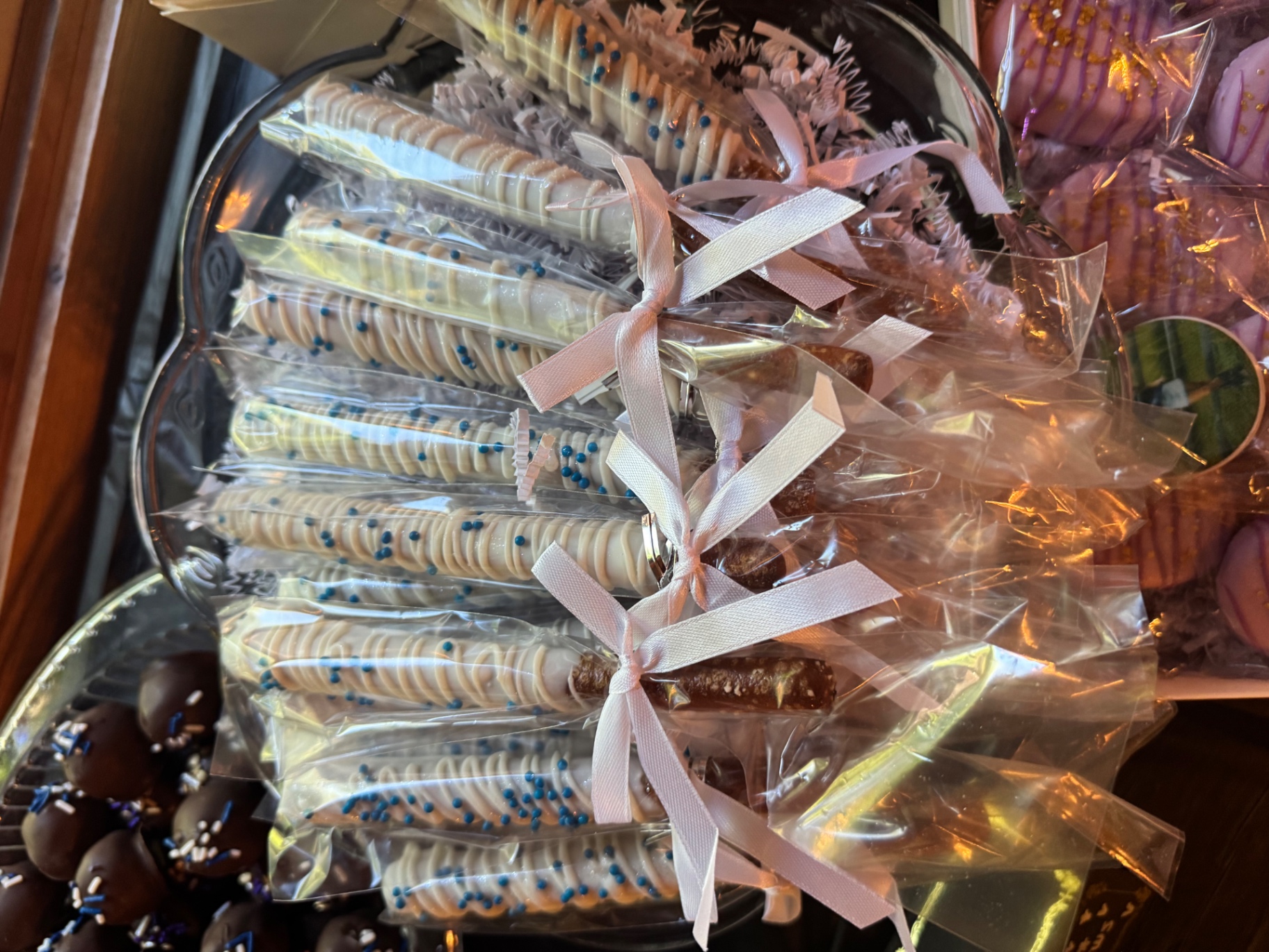 White chocolate dipped pretzel rods with blue sprinkles