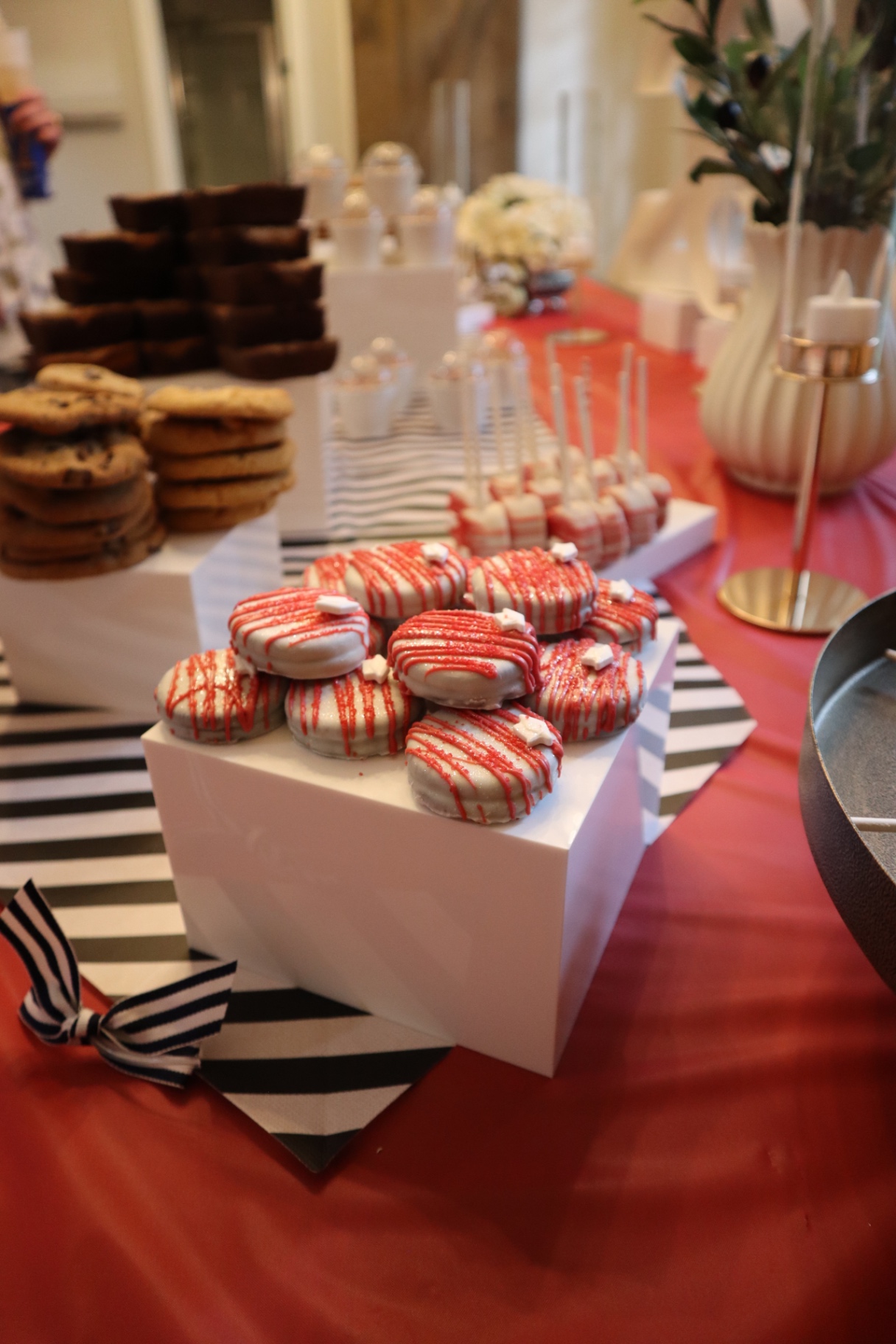 Chocolate chip cookies, brownies, and red drizzle Oreos along the Class of 2026 dessert table
