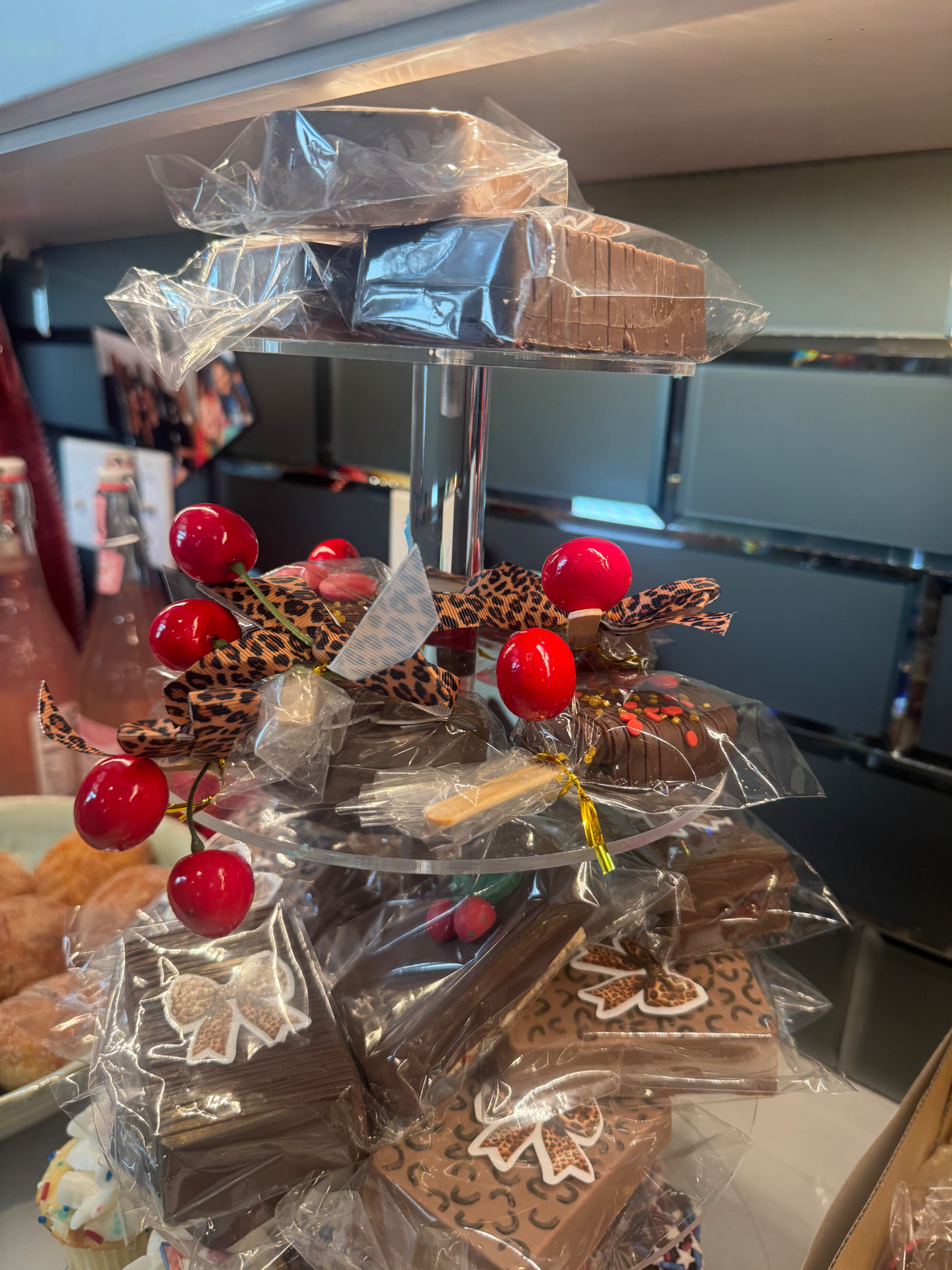 Tiered tower of cherry cheetah birthday treats with candy cherries and leopard ribbon accents