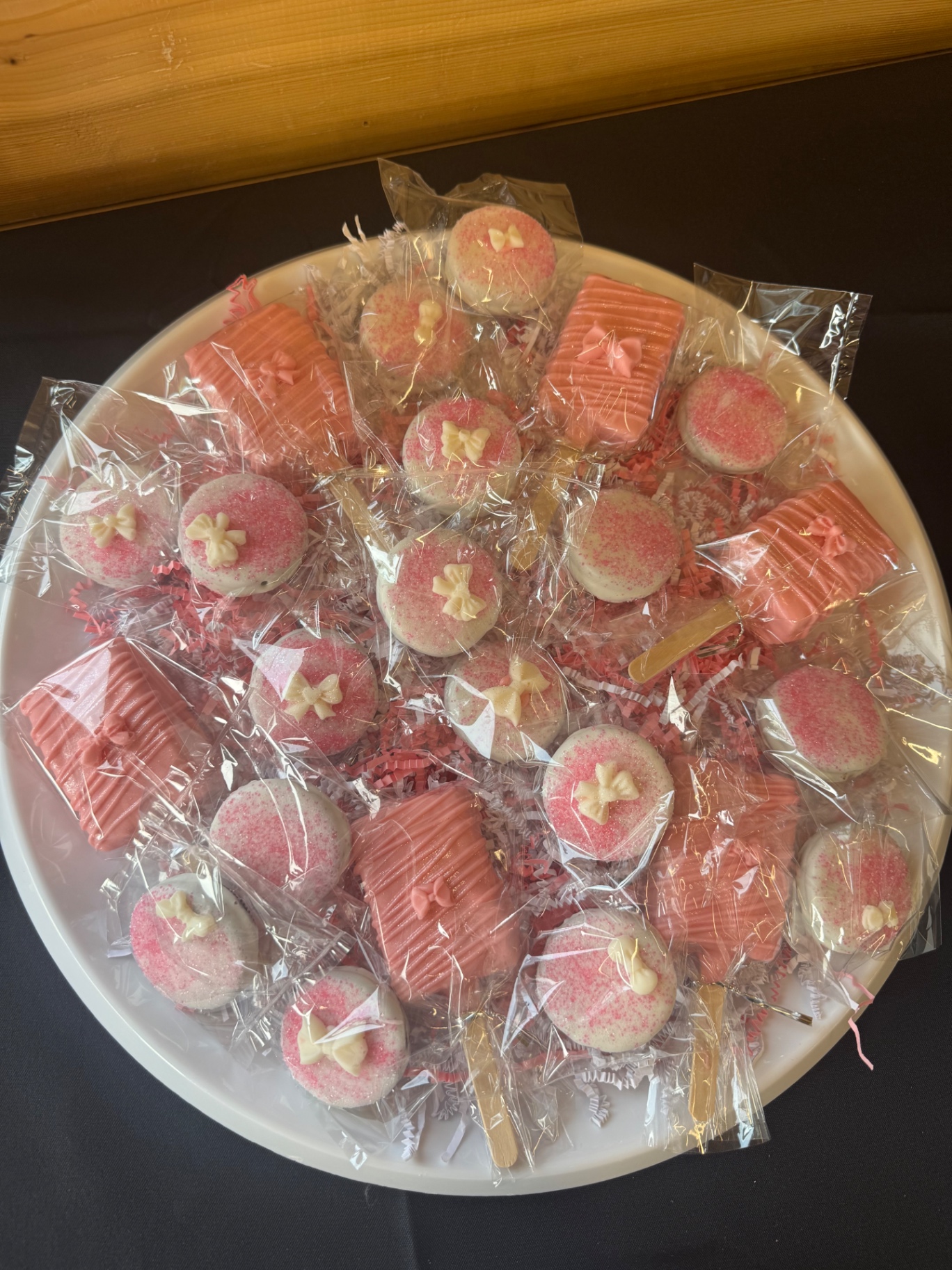 Pink graduation party treats including cake pops and chocolate covered desserts
