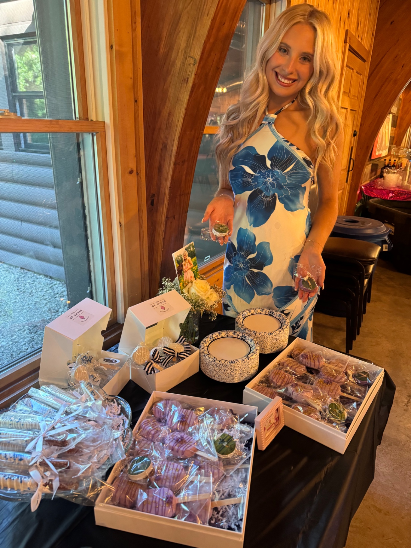 Graduate posing with her Pop of Sugar sweet table
