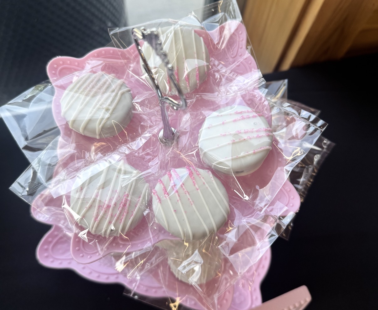 Pink dipped Oreos on a tiered display