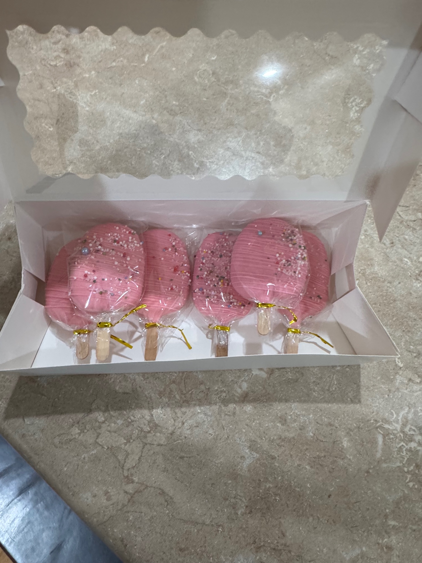 Pink sprinkle drizzle cakesicles in a gift box for a birthday order