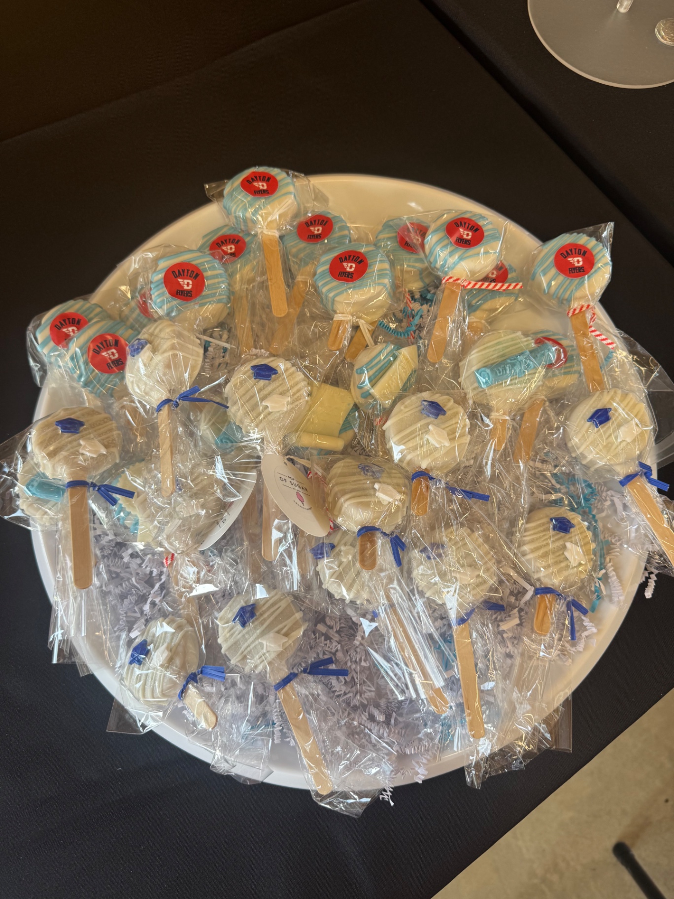 Dayton Flyers themed cake pops and graduation treats on a platter