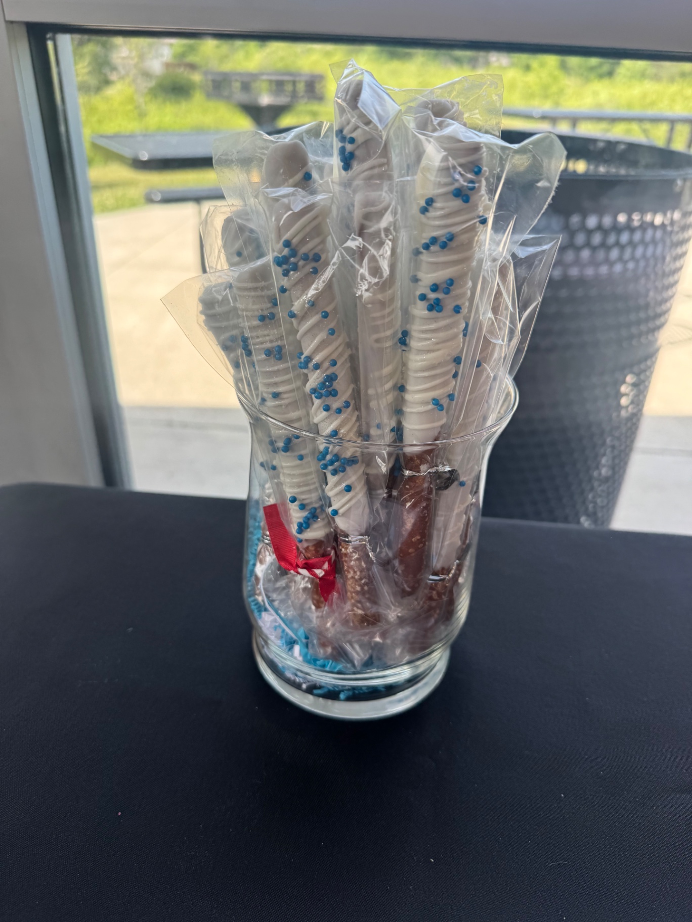 Graduation party pretzel rods displayed upright in a glass vase