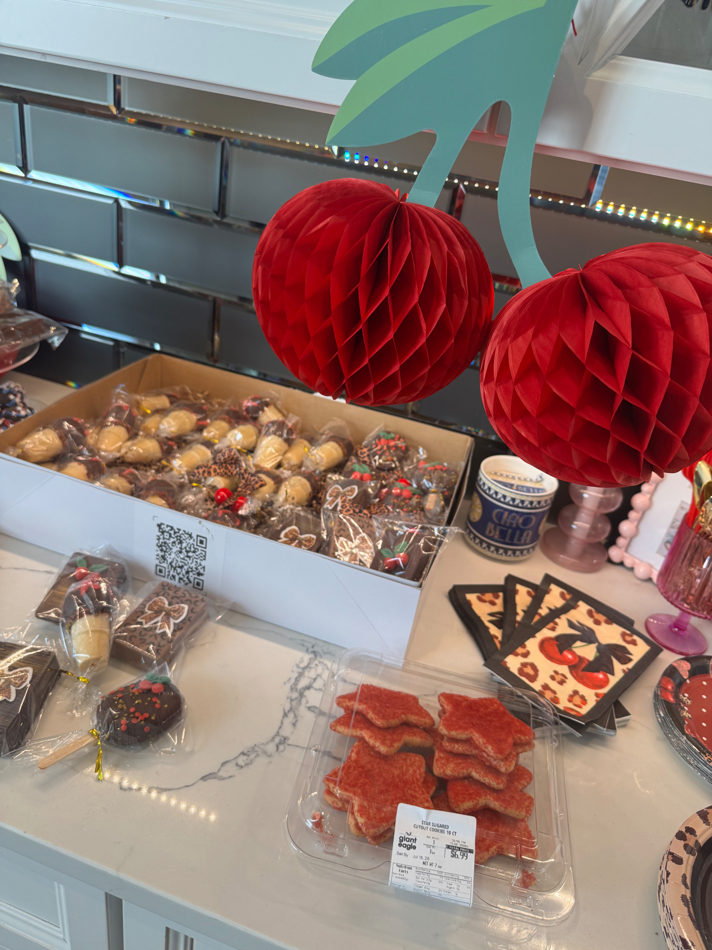 Cherry cheetah themed birthday display table with dipped treats and paper cherry decorations