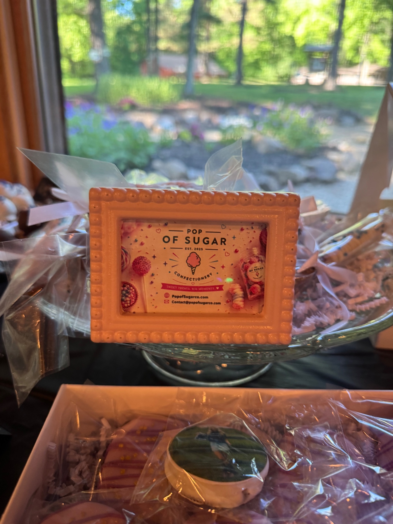 Pop of Sugar branded display card on the grad party table