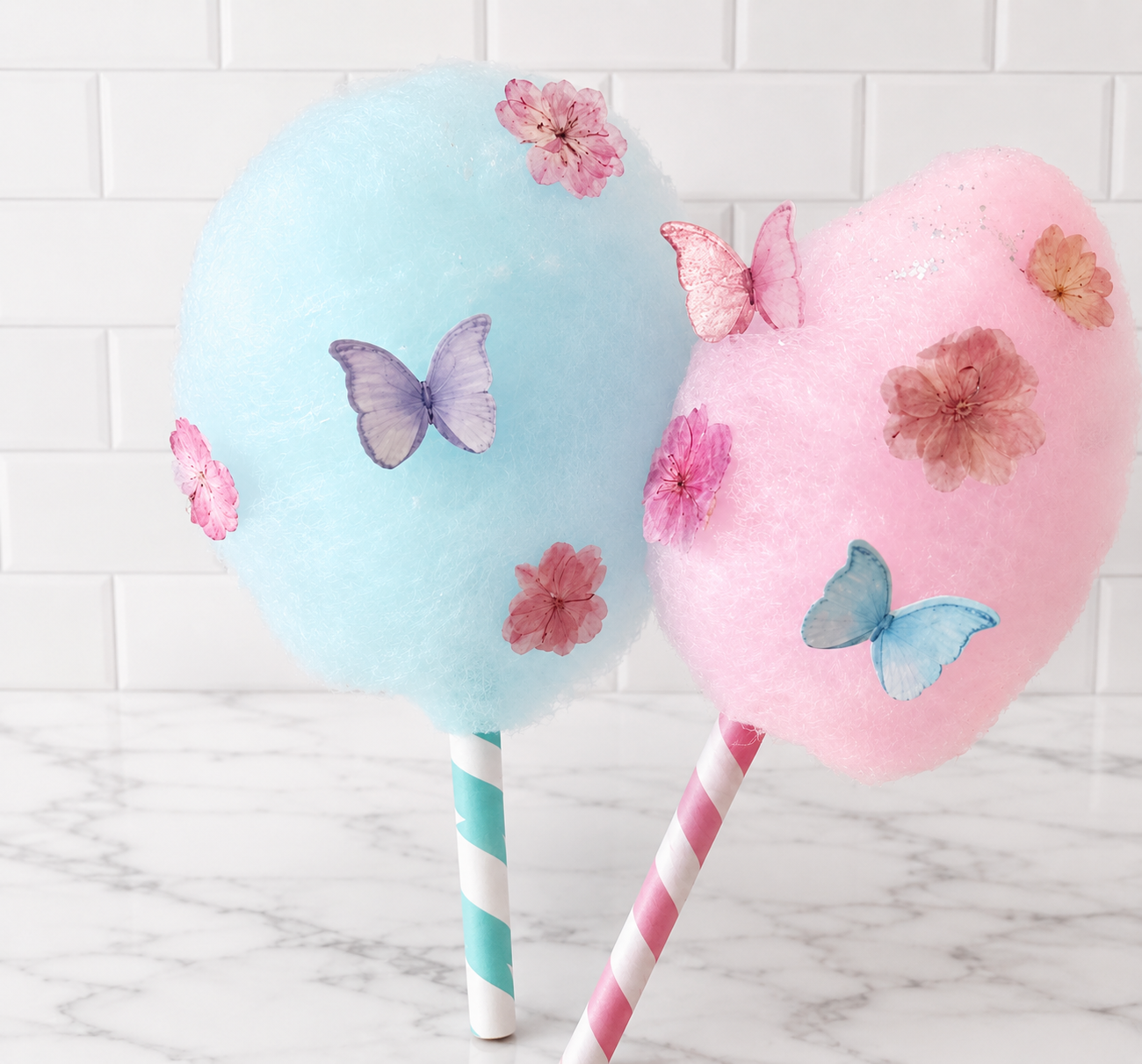 Fresh pink cotton candy on a stick with the Pop of Sugar logo
